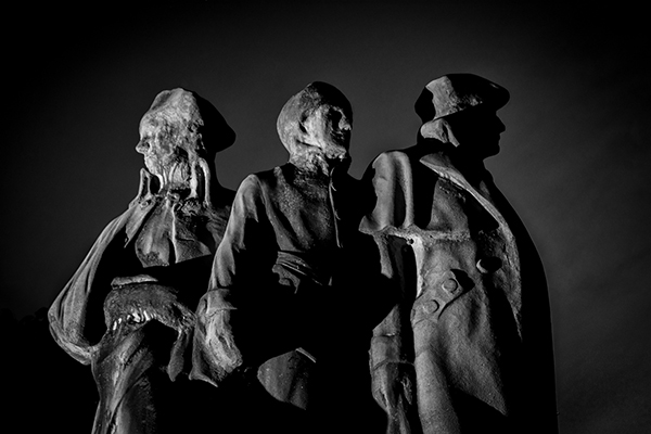 Black and white image shot after dark was lit with an off camera flash from the left side of the image.