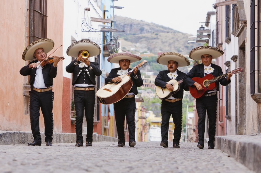 Photograph Mariachi band walking in street by Gable Denims on 500px