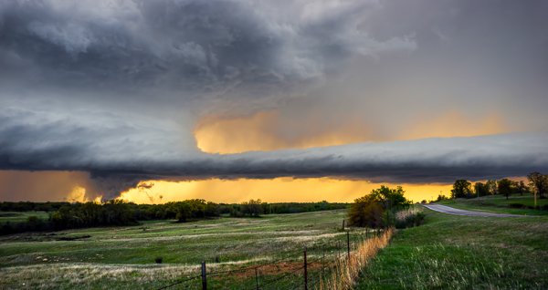 I haven't photographed a tornado yet, but this is about as close as I've come. This wall cloud (the section of a storm where tornadoes DO come from) began lowering behind the tree line while rotating quite rapidly. © James Brandon