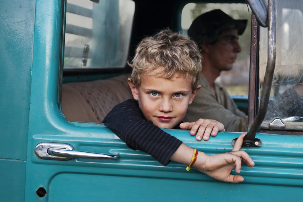 A young boy looks out the window of a truck, Brazil, 2010