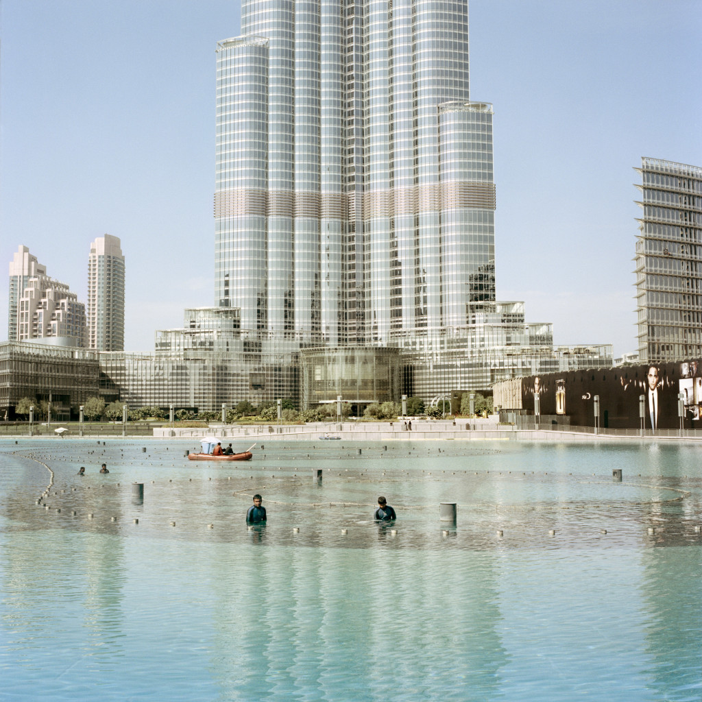 U.A.E. Dubai. Workers clean the Dubai fountain in front of the Burj Khalifa. 2013